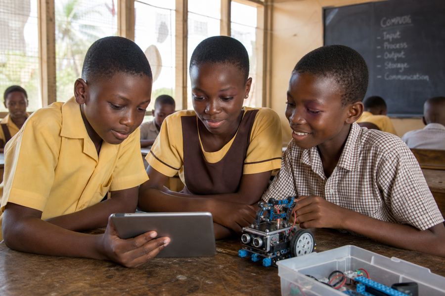 Ghanaian primary school children exploring tablets and robotics